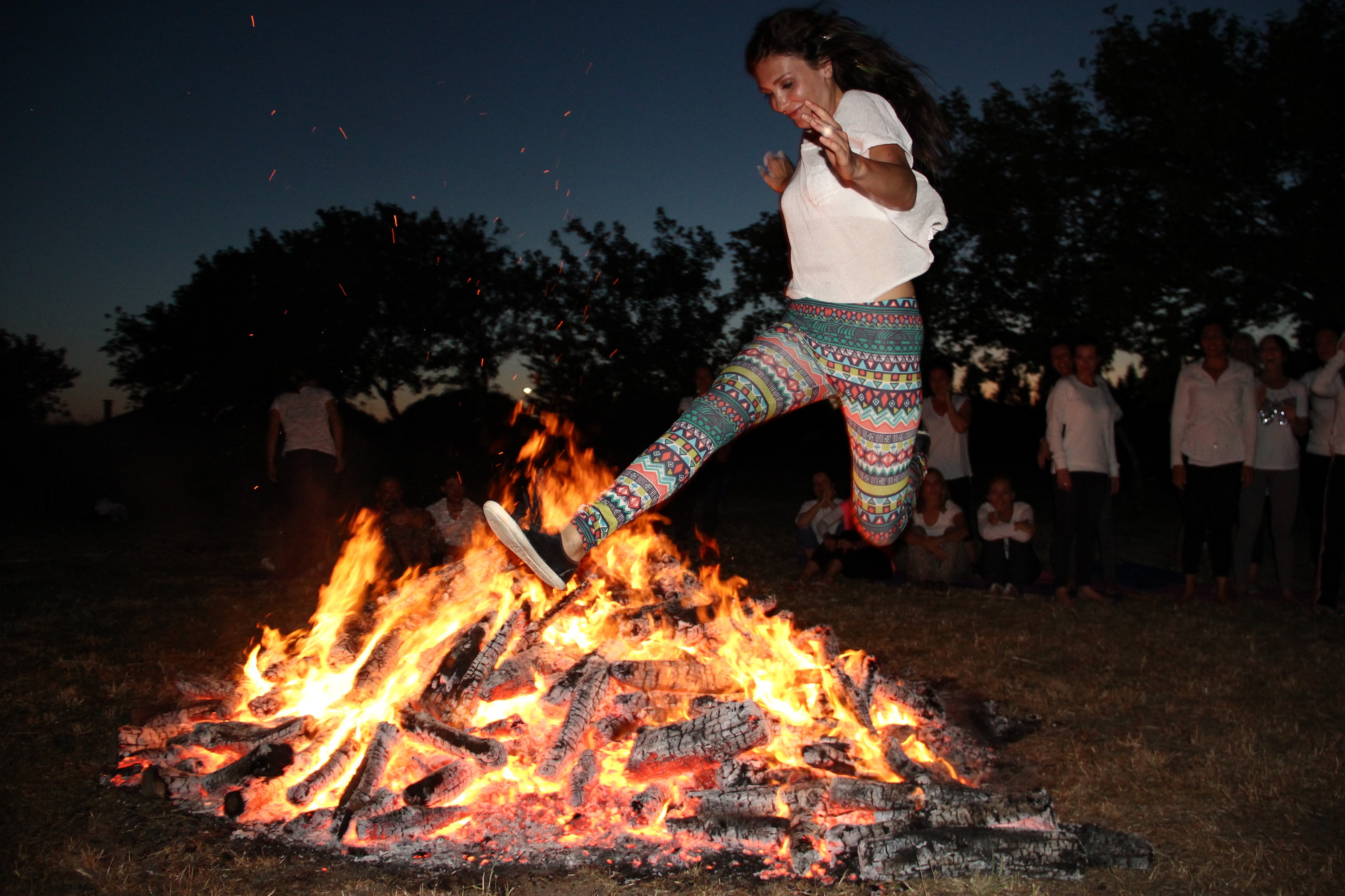 A participant taking an energetic step across a fire