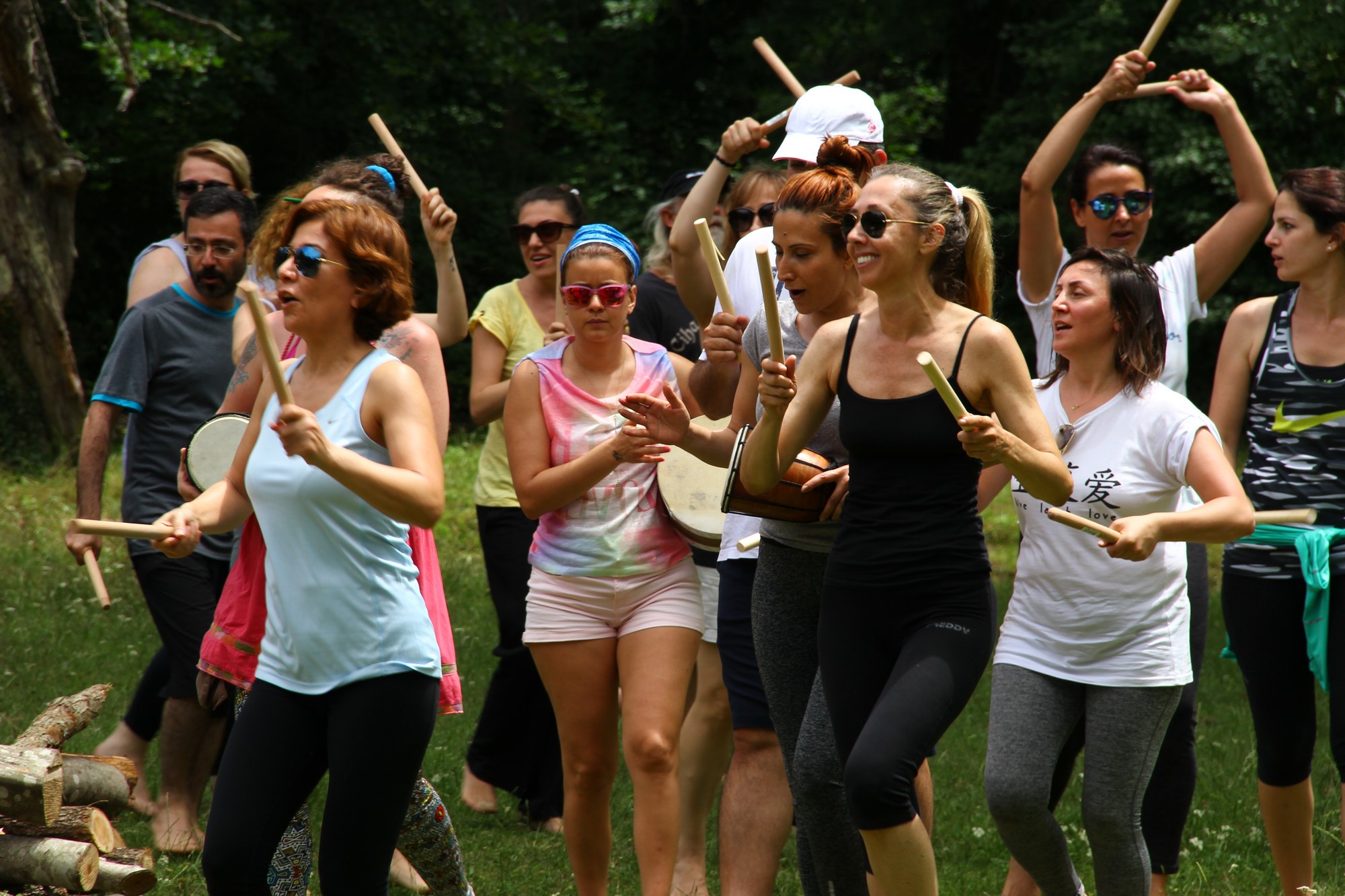 Participants moving together with drums and rhythm sticks