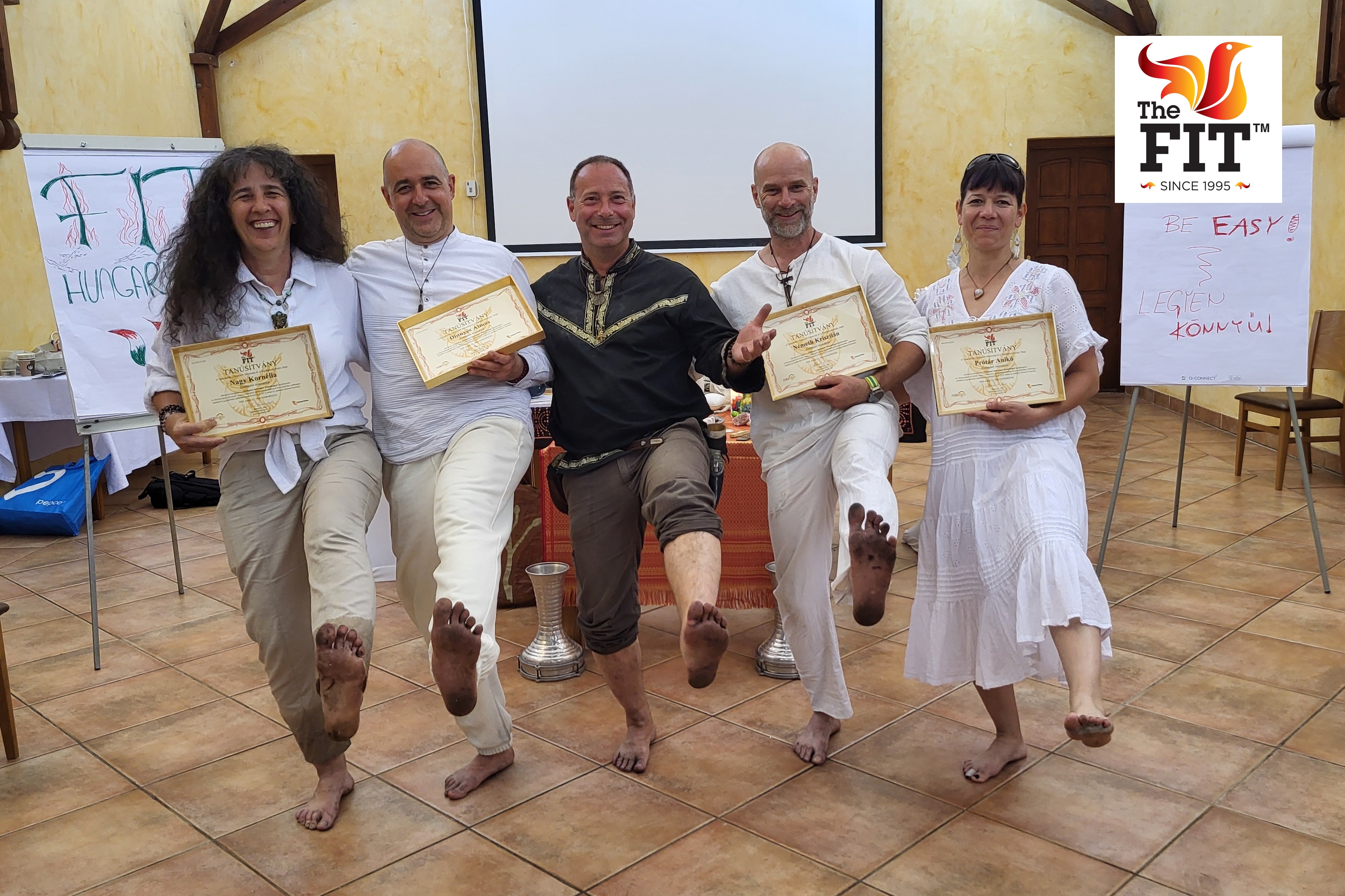 FIT graduates holding their international certificates after completing the training