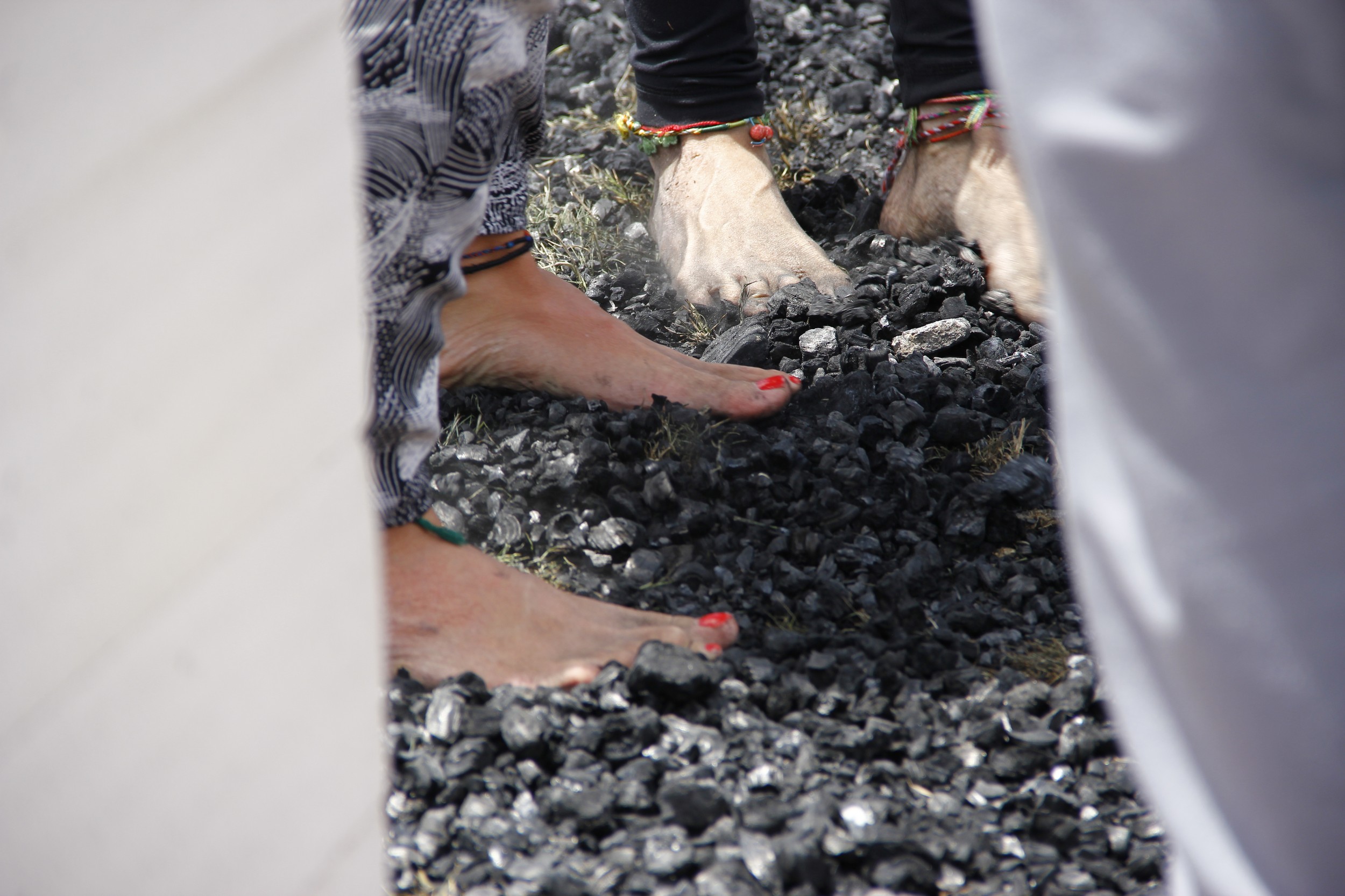 Bare feet making a conscious step across a prepared coal bed