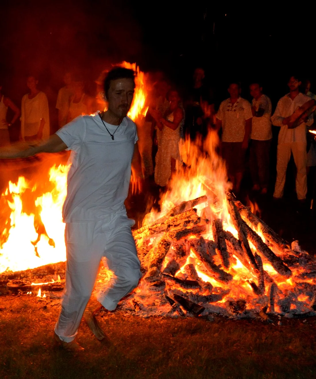 A participant moving between fires during a Four Seasons gathering