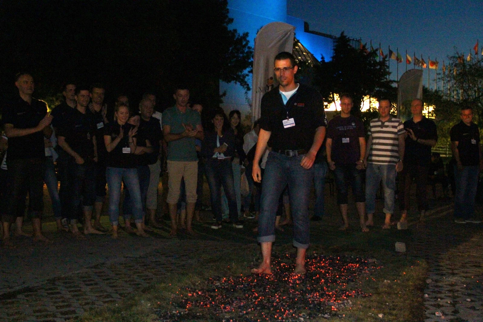 A charity firewalk participant crossing a glowing ember lane