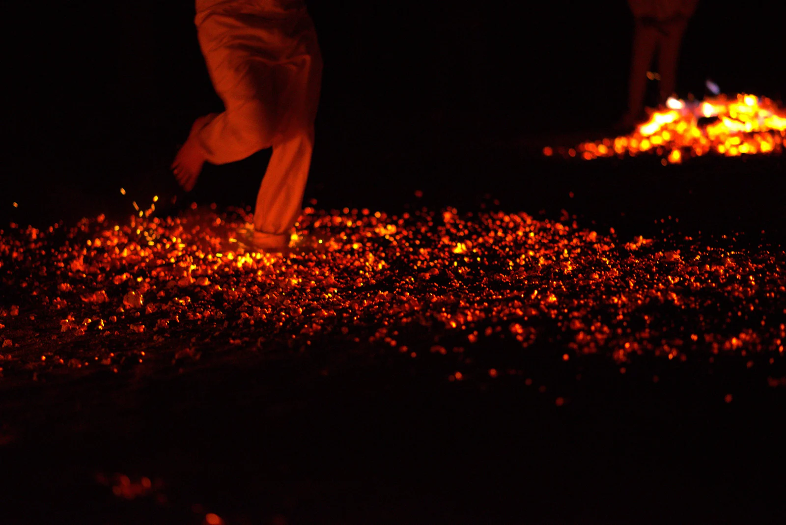 Barefoot steps on glowing embers
