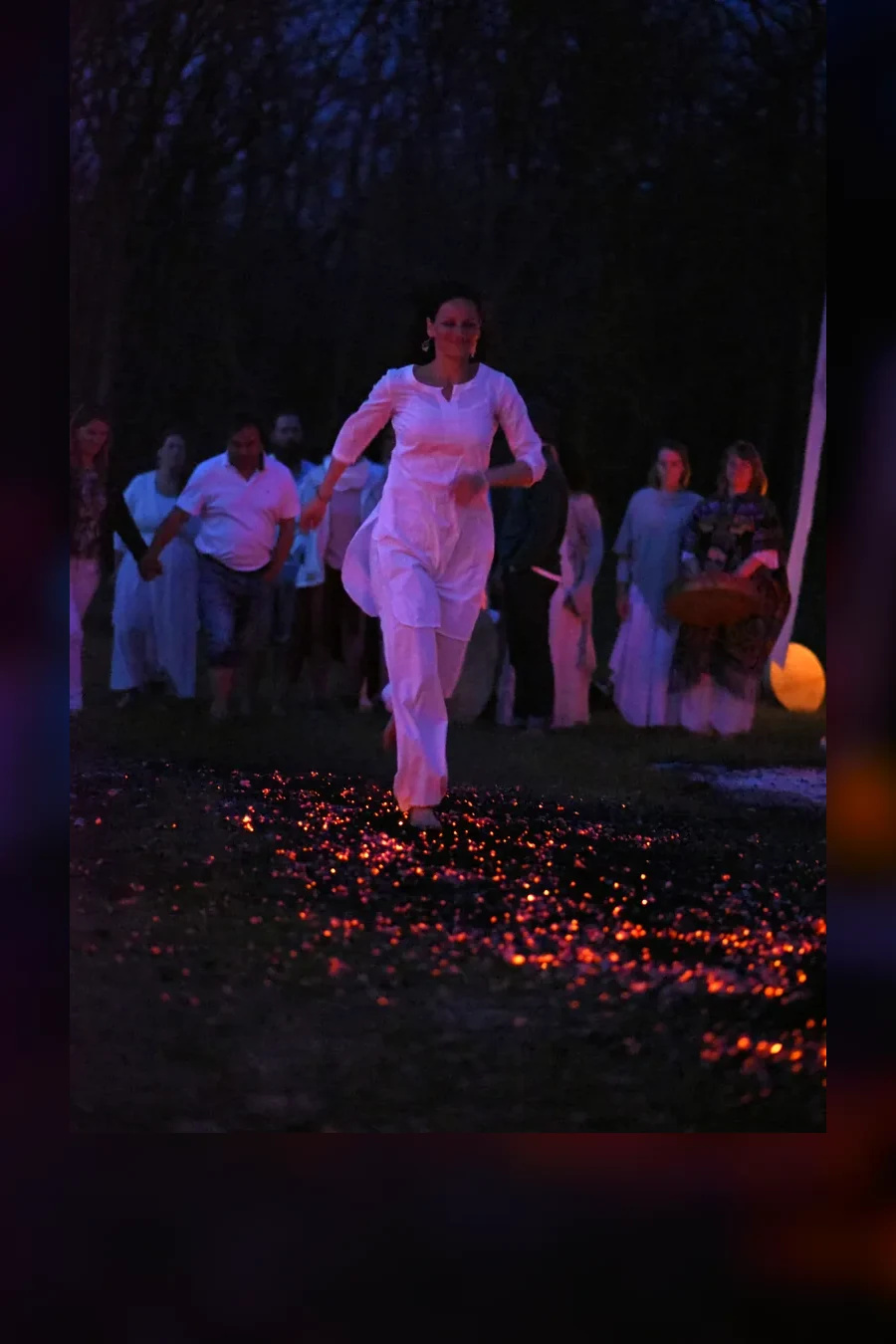 Participant crossing glowing embers during a firewalk