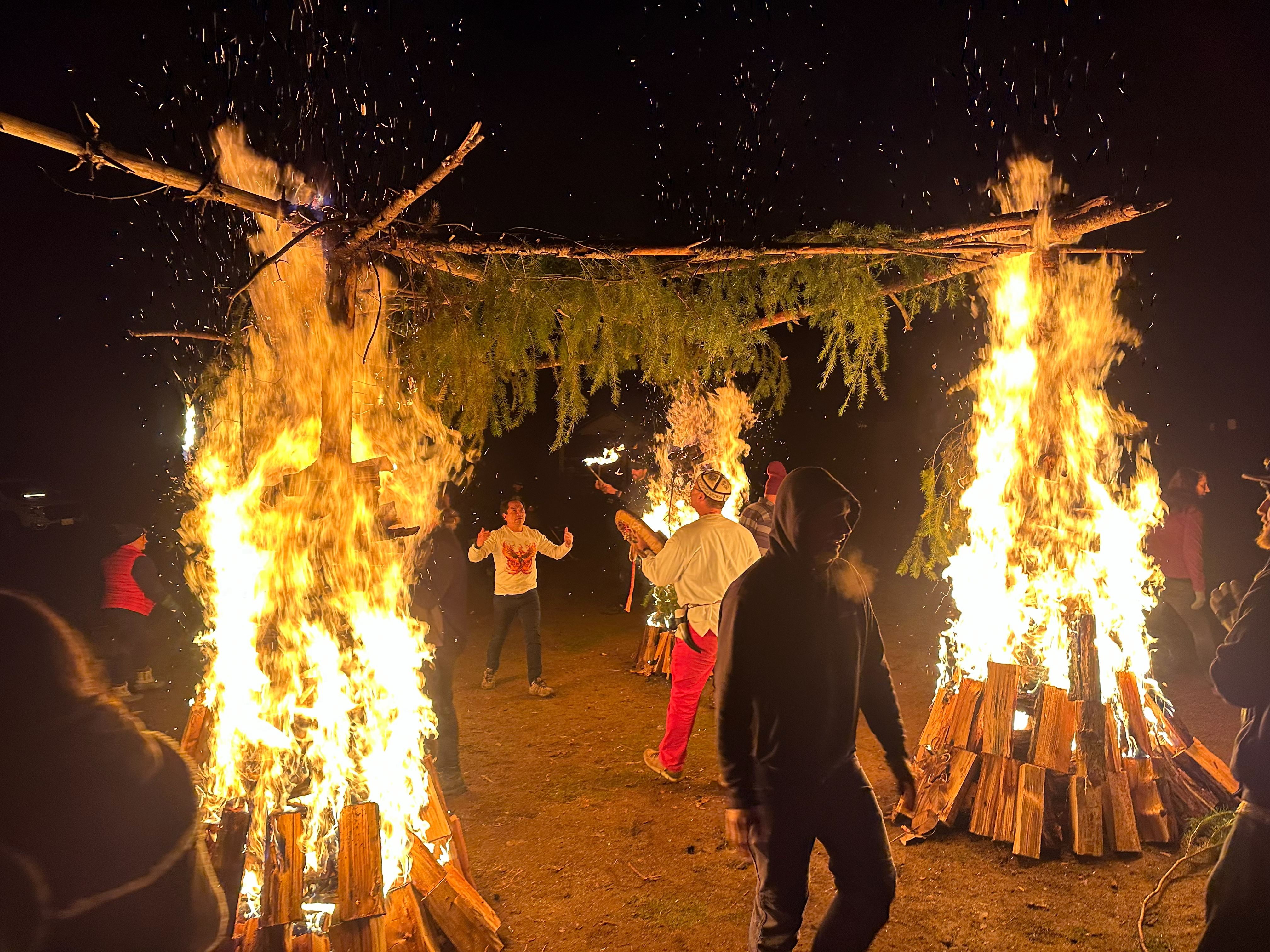 Participants standing between the burning pillars of a fire temple