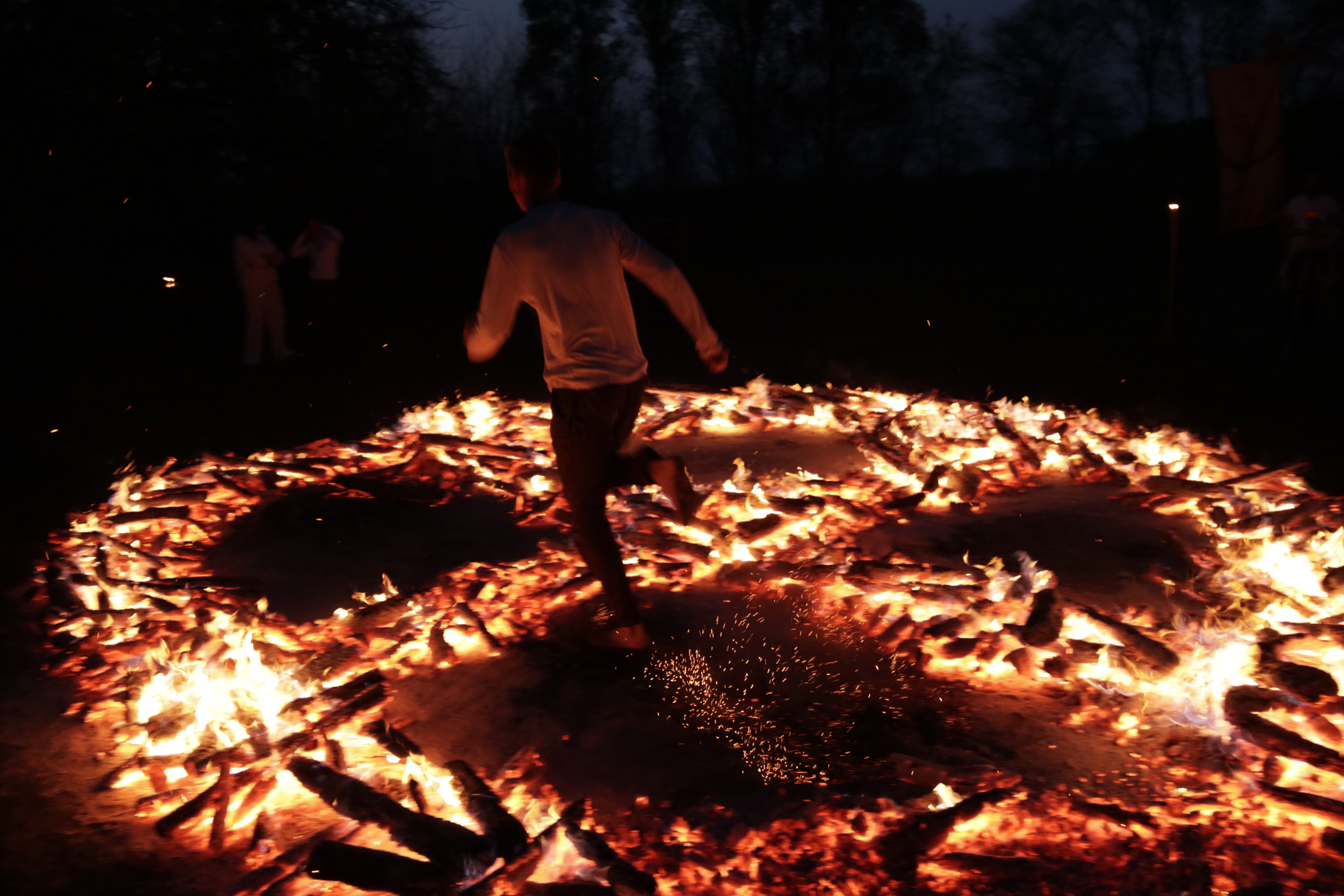 A participant moving through a circular medicine-wheel firewalk