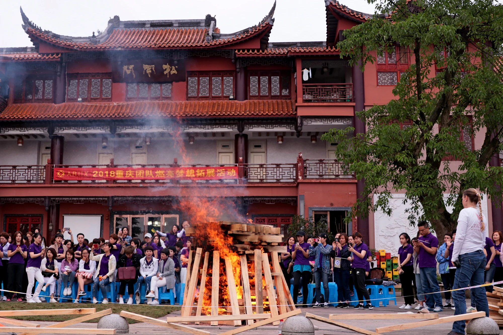Corporate firewalking event in front of a traditional building in Chongqing