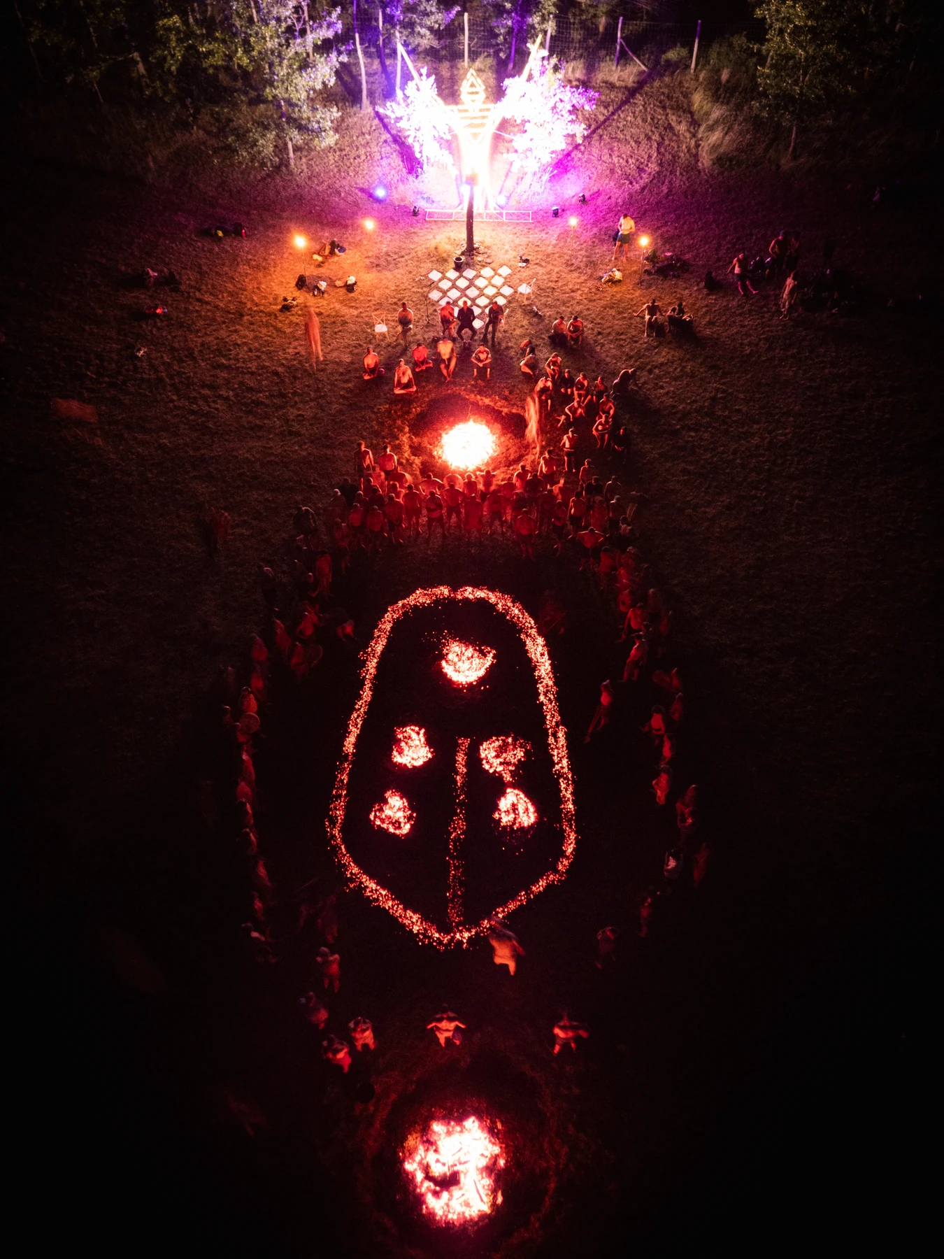Aerial view of a large ceremonial firewalk and its glowing ember formations