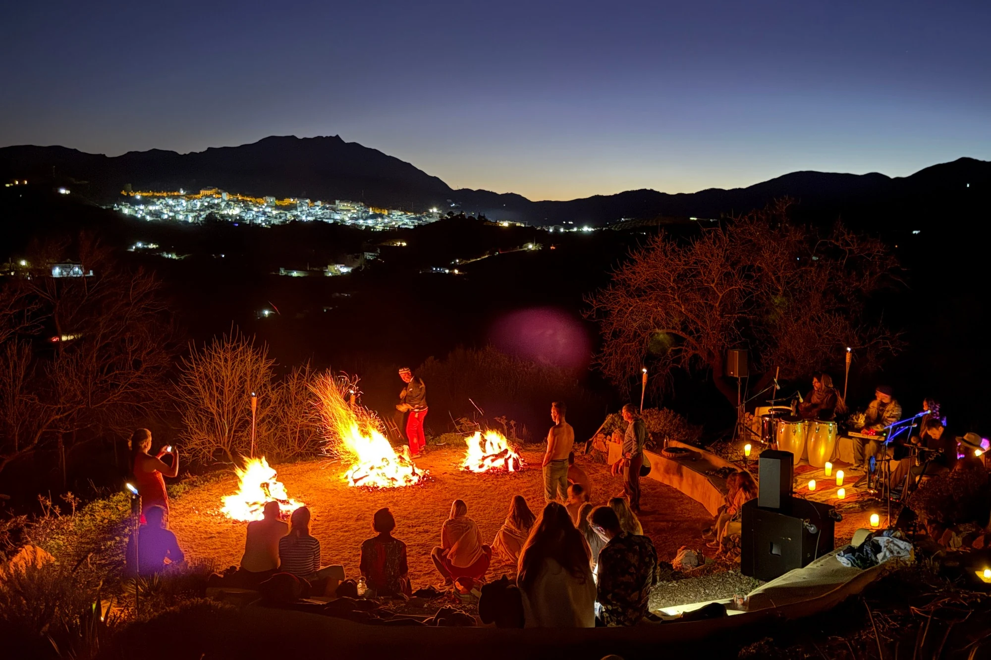 A firewalking gathering at Costa del Soul beneath the evening sky